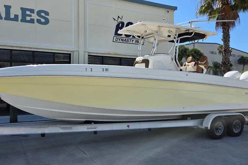The Image of 2008 Key West 293 Center Console boat on trailer, parked outside dealership. - 0