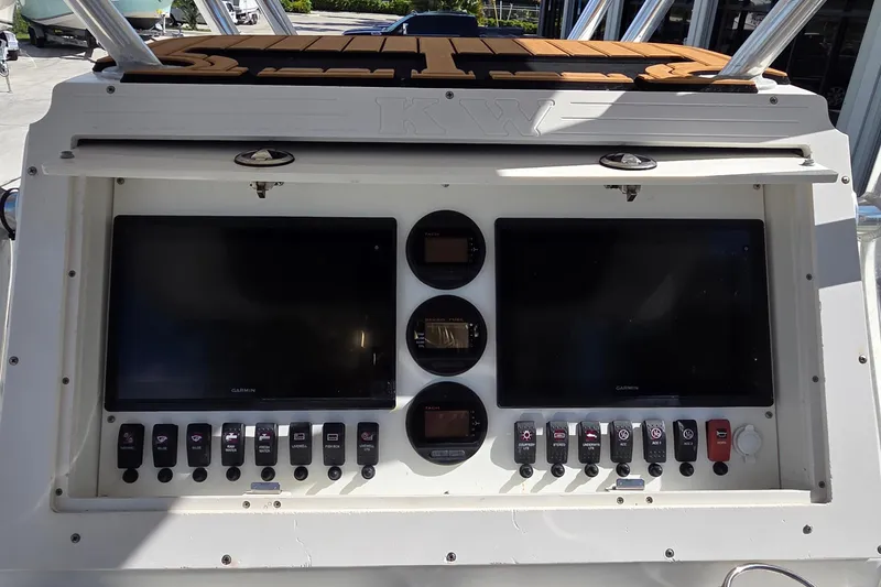 Slide: The Image of Console of 2008 Key West 293 Center Console boat with dual Garmin displays and control switches. - 10