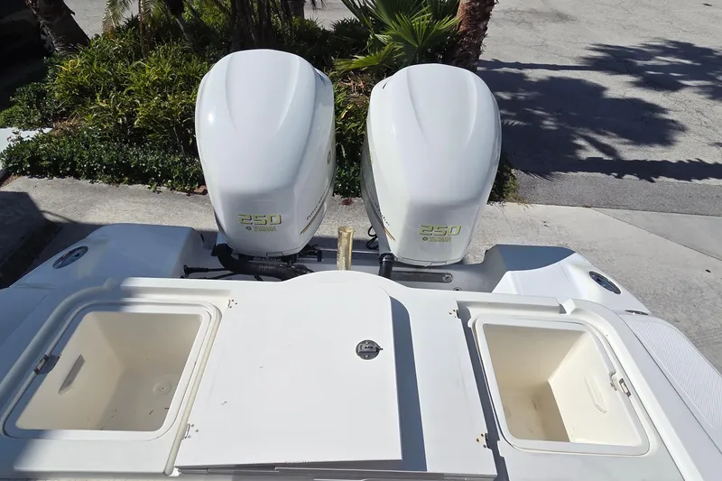 Slide: The Image of 2008 Key West 293 Center Console with twin Yamaha 250 engines, open storage compartments. - 12