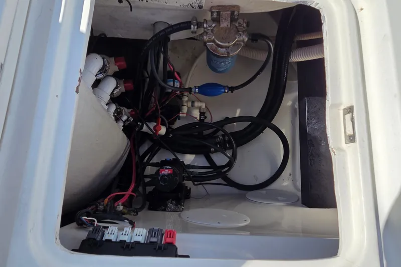 Slide: The Image of 2008 Key West 293 Center Console boat compartment with wiring and plumbing components. - 13