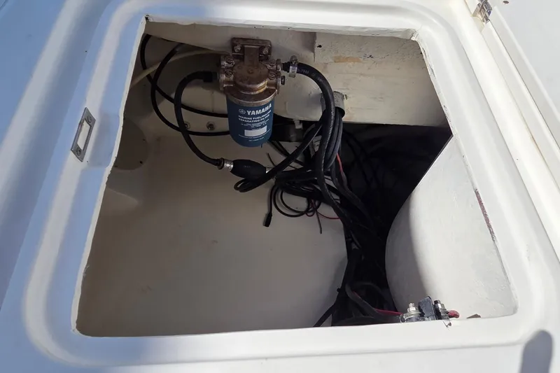 Slide: The Image of Open compartment of 2008 Key West 293 Center Console boat showing Yamaha fuel filter and wiring. - 14