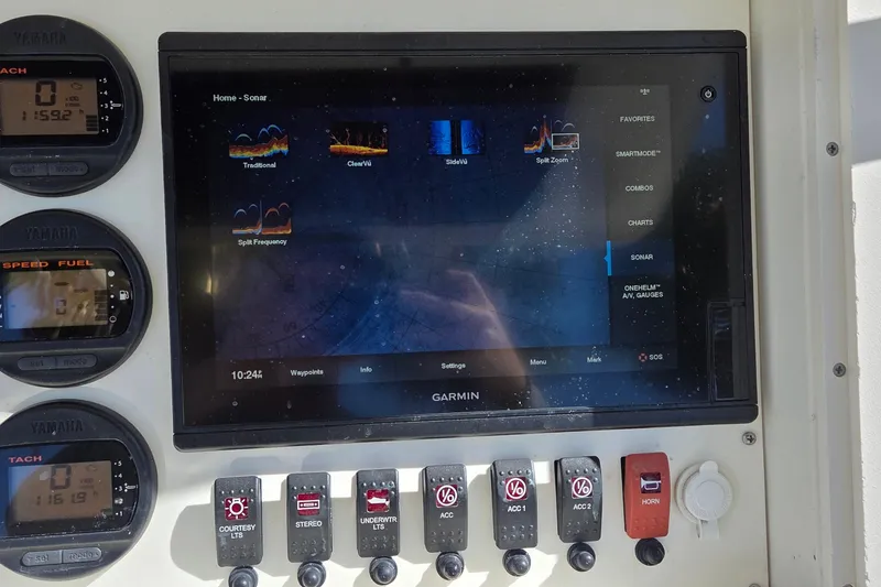 Slide: The Image of Garmin sonar display and controls on 2008 Key West 293 Center Console boat dashboard. - 18