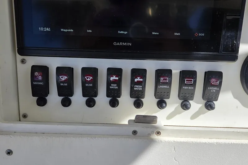 Slide: The Image of Control panel of a 2008 Key West 293 Center Console boat with various switches. - 20