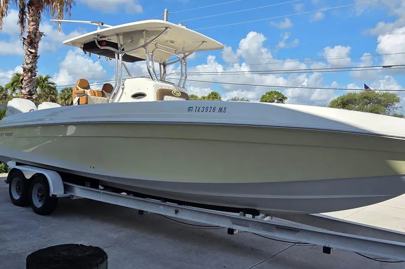 Slide: The Image of 2008 Key West 293 Center Console boat on trailer under blue sky. - 3
