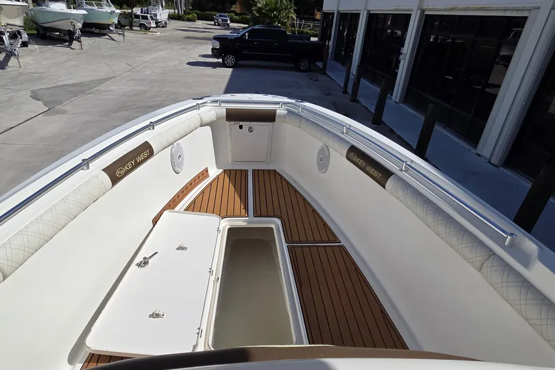Slide: The Image of 2008 Key West 293 Center Console boat interior with teak flooring and storage compartments. - 9