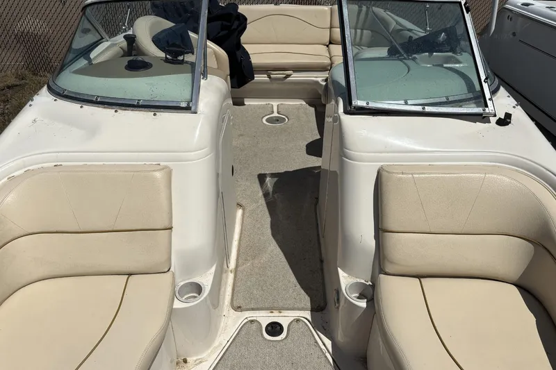 Slide: The Image of 2001 Sea Ray 210 Sundeck boat on trailer, covered, parked outdoors. - 10