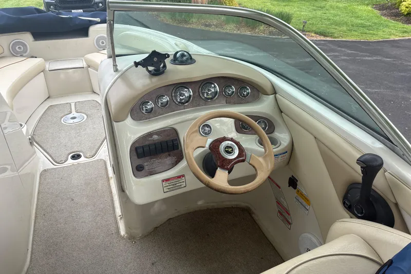 Slide: The Image of Interior view of a 2001 Sea Ray 210 Sundeck boat, featuring steering wheel and dashboard controls. - 4