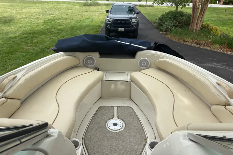 Slide: The Image of 2001 Sea Ray 210 Sundeck boat on trailer, covered, parked near garage. - 9