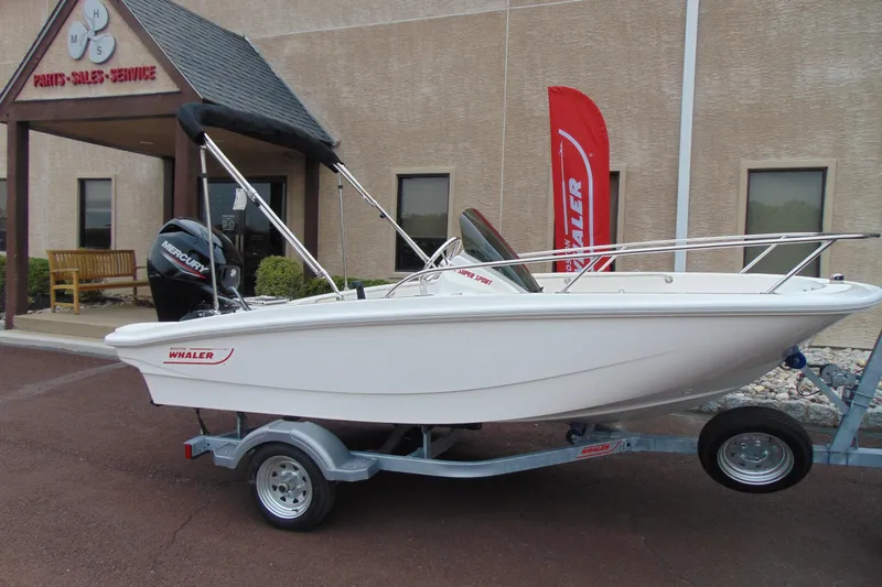 The Image of 2026 Boston Whaler 130 Super Sport boat on trailer outside dealership. - 1