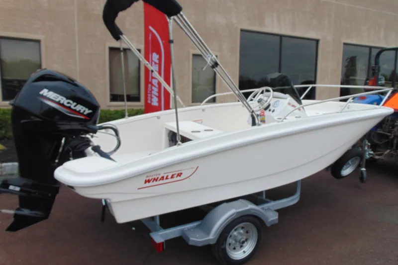 Slide: The Image of 2026 Boston Whaler 130 Super Sport boat on trailer with Mercury engine. - 3