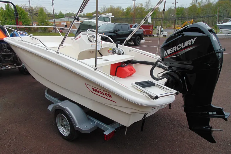 Slide: The Image of 2026 Boston Whaler 130 Super Sport boat with Mercury engine on trailer. - 6