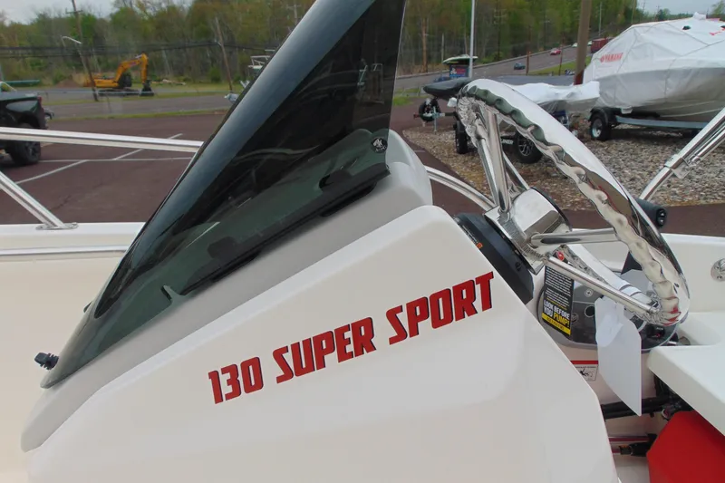 Slide: The Image of 2026 Boston Whaler 130 Super Sport boat dashboard with steering wheel and windshield. - 7