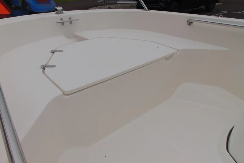 Slide: The Image of 2026 Boston Whaler 130 Super Sport boat interior with storage compartment. - 8