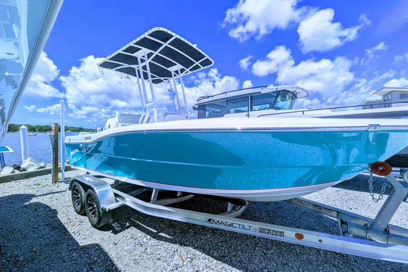 The Image of Clearwater 2000 Center Console boat, 2026 model, on trailer by the water. - 0