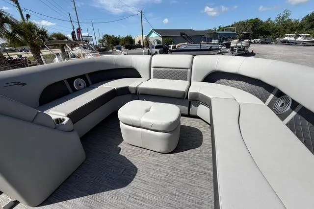 Slide: The Image of Luxurious seating area on a 2021 Bennington L22 pontoon boat, featuring plush gray upholstery. - 10