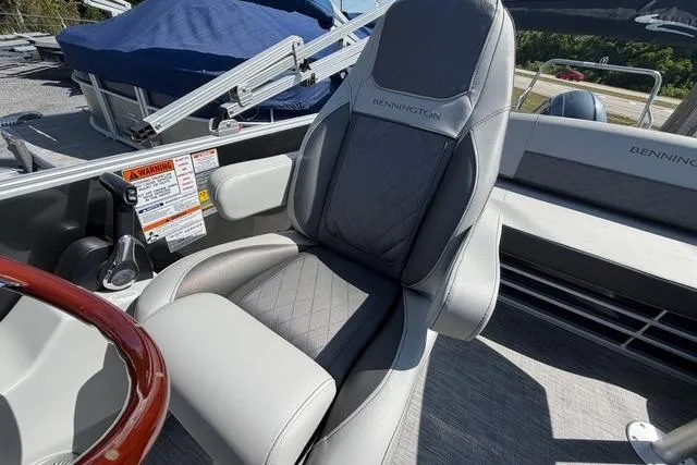 Slide: The Image of Captain's chair on 2021 Bennington L22 pontoon boat, featuring gray upholstery and sleek design. - 12