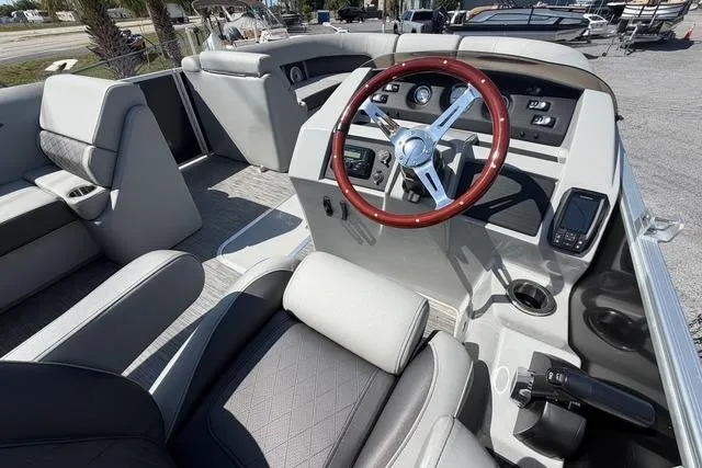 Slide: The Image of 2021 Bennington L22 boat interior with steering wheel and seating. - 13