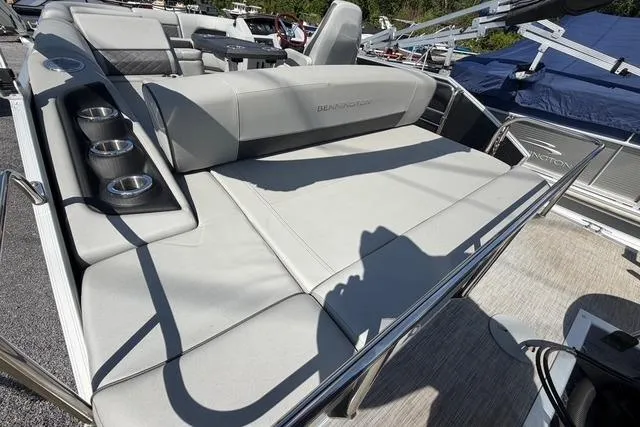 Slide: The Image of 2021 Bennington L22 pontoon boat with spacious seating and cup holders. - 14