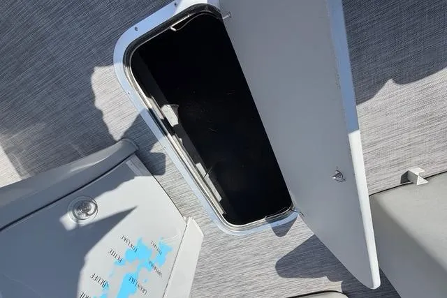 Slide: The Image of Open storage compartment on 2021 Bennington L22 boat deck. - 17