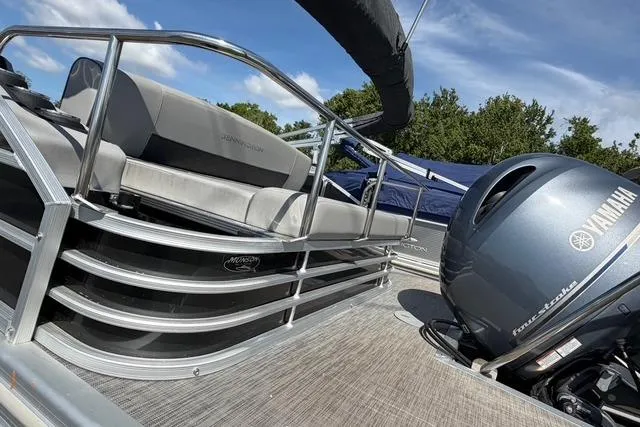 Slide: The Image of 2021 Bennington L22 pontoon boat with Yamaha outboard motor, featuring sleek seating and railing. - 6