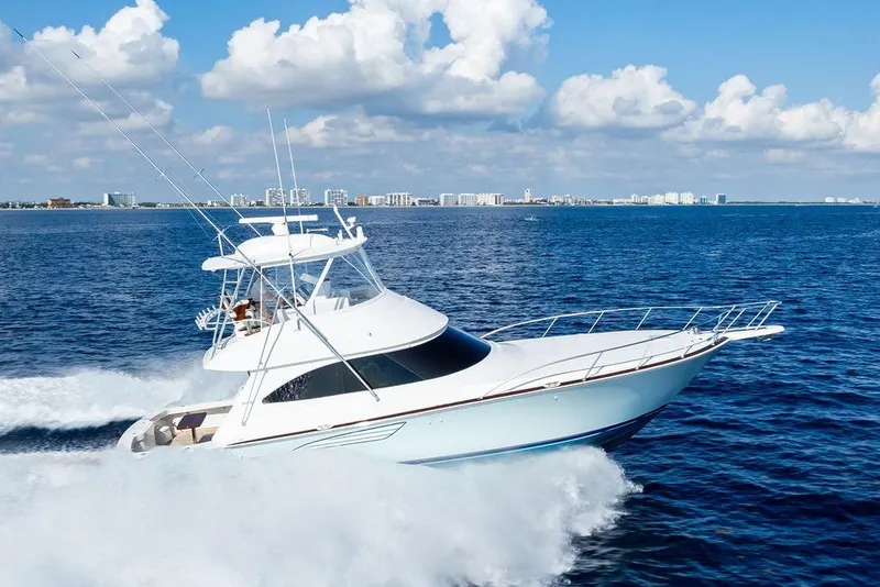 Slide: The Image of 2022 Viking 48 Convertible yacht cruising on open blue ocean under clear skies. - 12