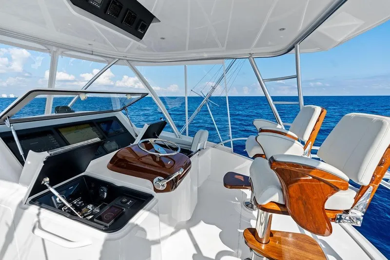 Slide: The Image of Helm of 2022 Viking 48 Convertible yacht with ocean view and luxury seating. - 18