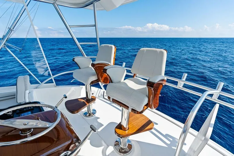 Slide: The Image of Luxury seating on 2022 Viking 48 Convertible yacht, overlooking the ocean. - 19
