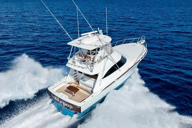 Slide: The Image of 2022 Viking 48 Convertible yacht cruising on open blue ocean waters. - 2