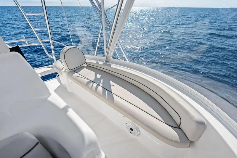 Slide: The Image of 2022 Viking 48 Convertible yacht, sleek seating, ocean view, sunny day. - 23