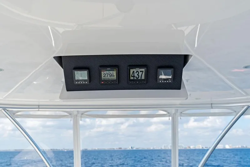 Slide: The Image of 2022 Viking 48 Convertible boat dashboard with digital displays, ocean view in background. - 29