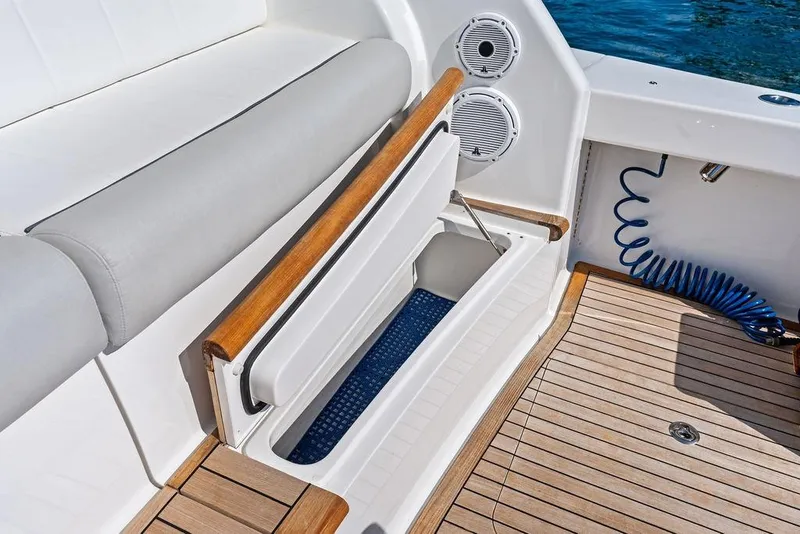 Slide: The Image of 2022 Viking 48 Convertible yacht interior with storage compartment and speakers. - 36