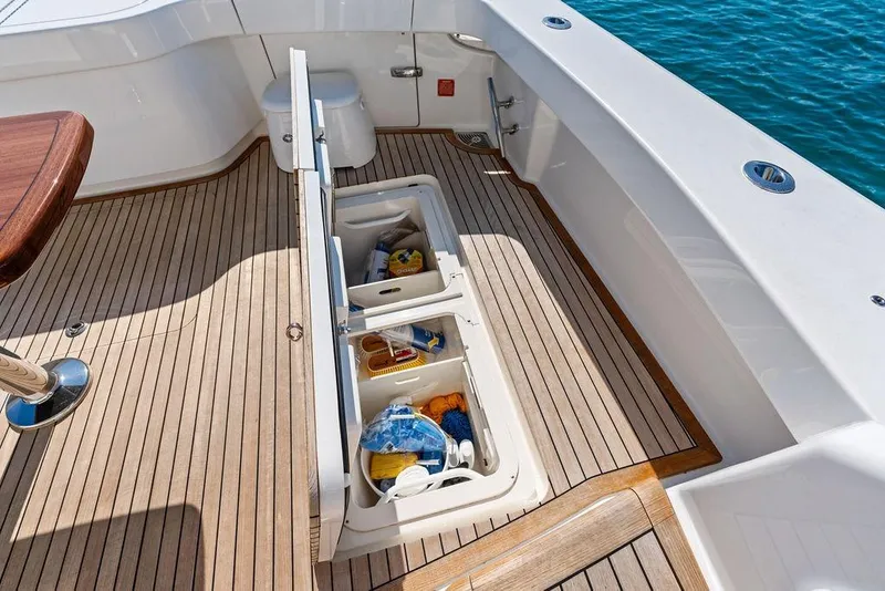 Slide: The Image of 2022 Viking 48 Convertible yacht deck with open storage compartments. - 39