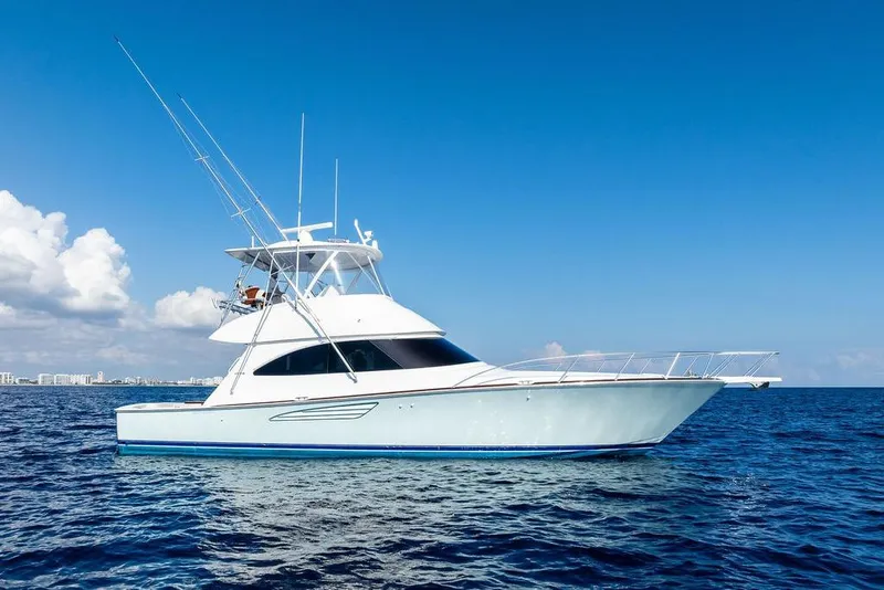 Slide: The Image of 2022 Viking 48 Convertible yacht cruising on open sea under clear blue sky. - 4