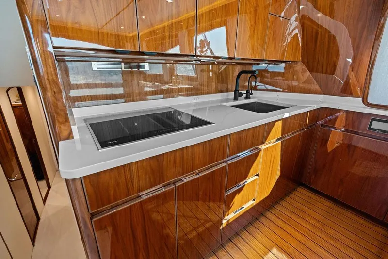 Slide: The Image of Luxurious kitchen interior of 2022 Viking 48 Convertible yacht with sleek wood finish. - 48