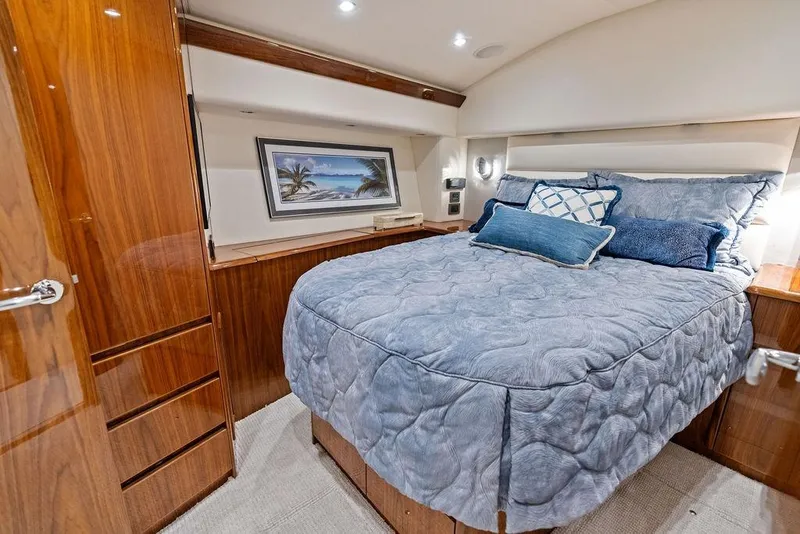 Slide: The Image of Luxurious bedroom interior of 2022 Viking 48 Convertible yacht with elegant wood finishes. - 52