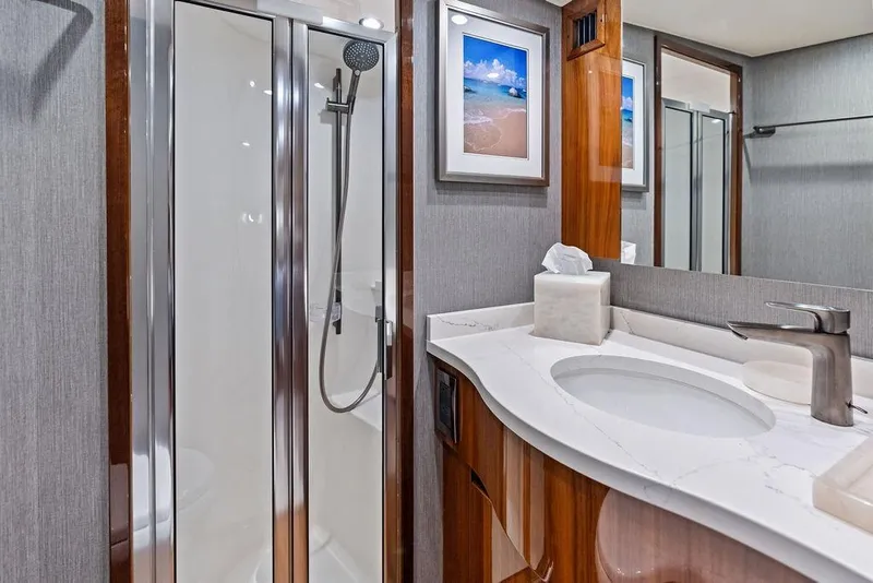 Slide: The Image of Luxurious bathroom in 2022 Viking 48 Convertible yacht with modern shower and elegant vanity. - 57