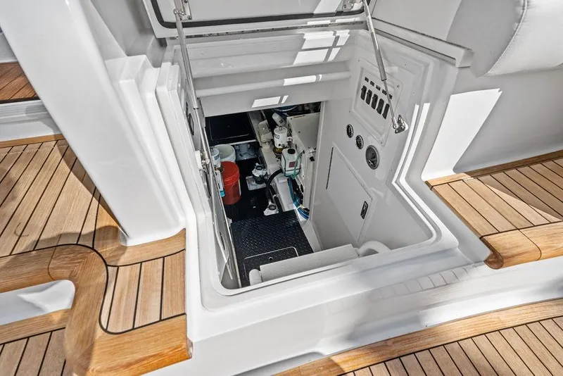Slide: The Image of Engine room access on 2022 Viking 48 Convertible yacht with teak flooring. - 64