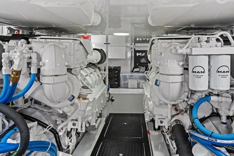 Slide: The Image of Engine room of 2022 Viking 48 Convertible yacht with MAN engines and blue hoses. - 67
