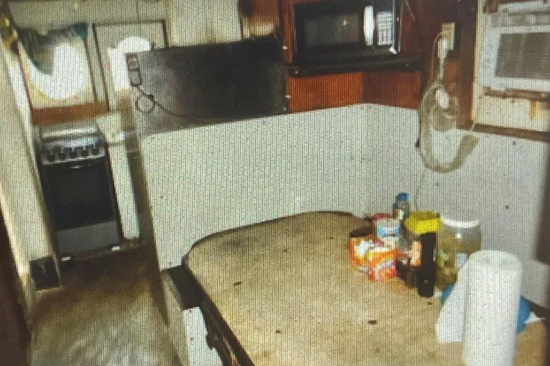 Slide: The Image of Interior of a 1987 commercial freezer shrimp trawler kitchen with appliances and supplies. - 2