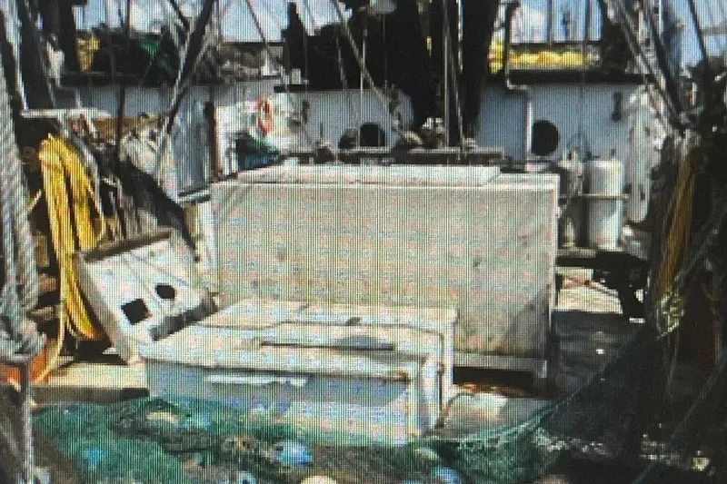 Slide: The Image of 1987 Commercial Freezer Shrimp Trawler deck with equipment and storage containers. - 7
