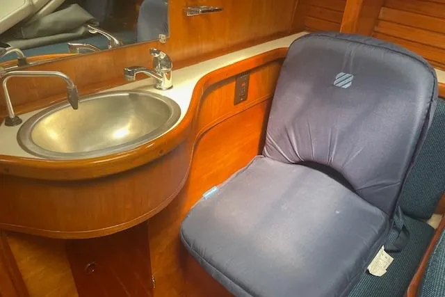 Slide: The Image of Interior of 1993 Sabre 38 yacht with sink and cushioned seating. - 11