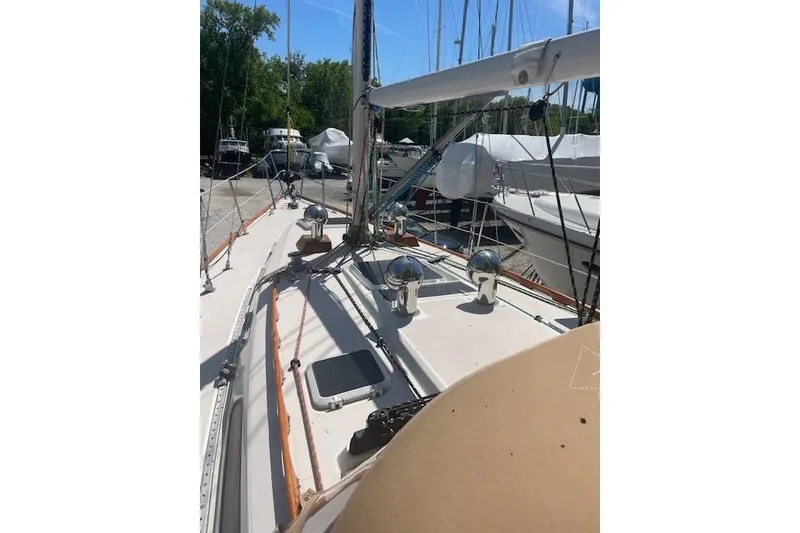 Slide: The Image of 1993 Sabre 38 sailboat deck view with rigging and winches in a marina. - 21