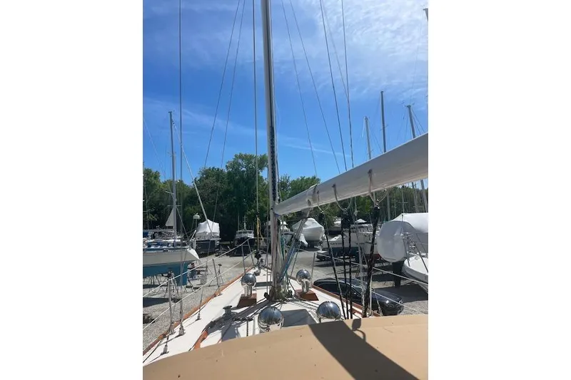 Slide: The Image of Sailboat deck view of 1993 Sabre 38, docked under clear blue sky. - 22