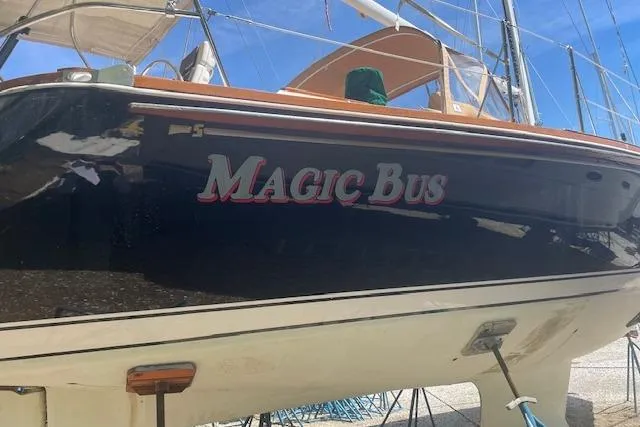 Slide: The Image of 1993 Sabre 38 sailboat named "Magic Bus" on dry dock under clear blue sky. - 26