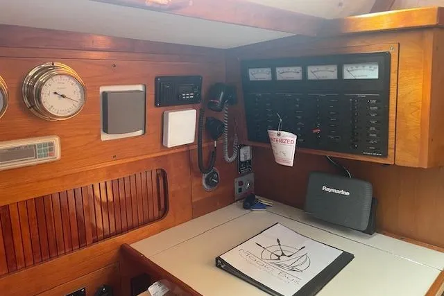 Slide: The Image of Navigation station of a 1993 Sabre 38 sailboat with control panels and instruments. - 9