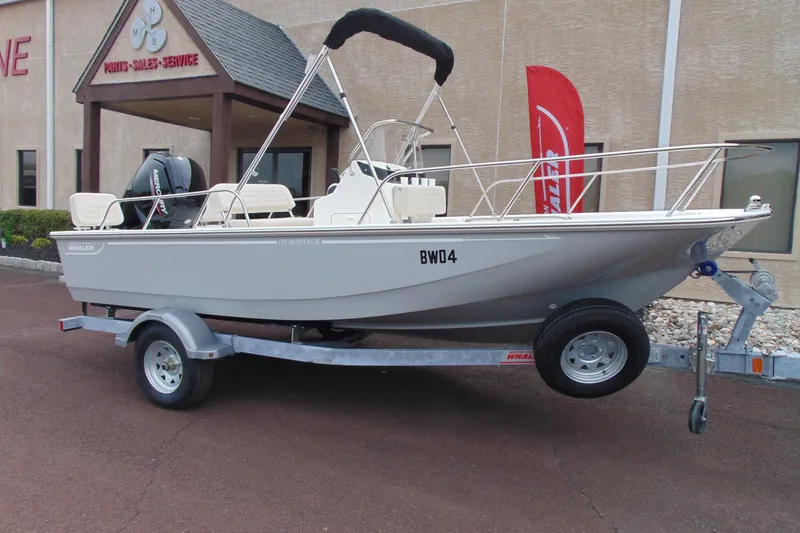 The Image of 2026 Boston Whaler 170 Montauk boat on trailer outside dealership. - 1