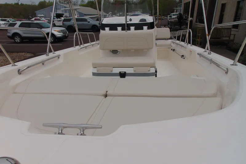 Slide: The Image of 2026 Boston Whaler 170 Montauk boat interior with white seating and railings. - 10