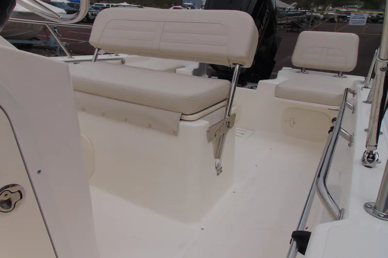 Slide: The Image of 2026 Boston Whaler 170 Montauk boat interior with beige seating and stainless steel railings. - 13