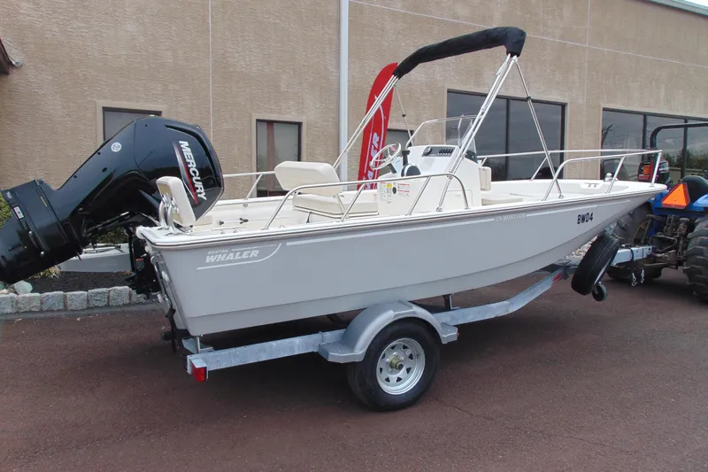 Slide: The Image of 2026 Boston Whaler 170 Montauk boat on trailer with Mercury engine. - 3