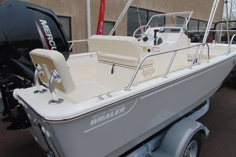 Slide: The Image of 2026 Boston Whaler 170 Montauk boat with Mercury engine, displayed on a trailer. - 4